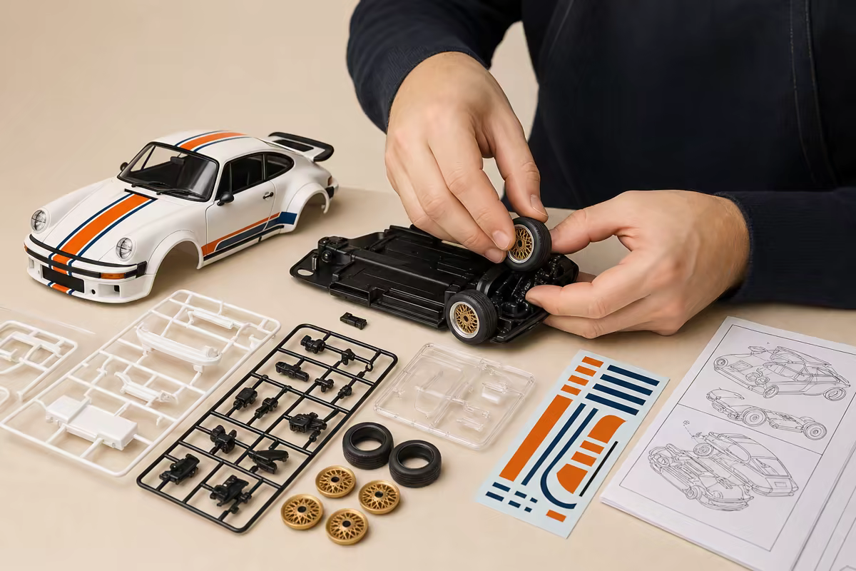 Hands assembling the Heritage 74 from its model parts.